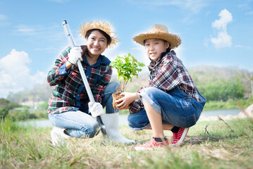 Ecology sapling tree growing up and planting on land. Hands kids Team work protecting and reduce...