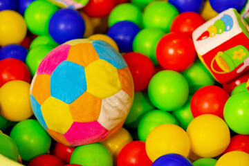 Colorful Soft Ball and Toy Truck in a Pit of Plastic Balls at an Indoor Playground