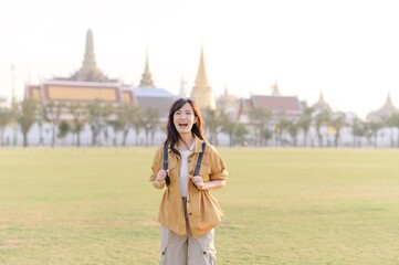 A Traveler Asian woman in her 30s exploring Wat Pra Kaew. From stunning architecture to friendly locals, she cherishes every moment, capturing it all in her heart and camera for years to come. - 792478083
