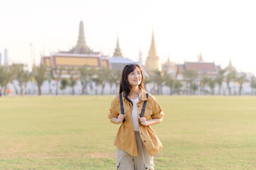 A Traveler Asian woman in her 30s exploring Wat Pra Kaew. From stunning architecture to friendly locals, she cherishes every moment, capturing it all in her heart and camera for years to come. - 792478085