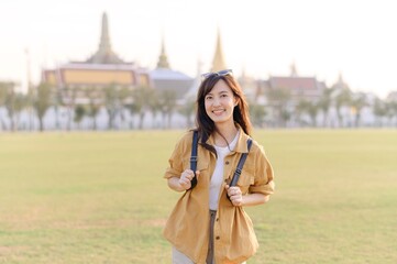 A Traveler Asian woman in her 30s exploring Wat Pra Kaew. From stunning architecture to friendly locals, she cherishes every moment, capturing it all in her heart and camera for years to come. - 792478093