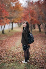 Portrait of a young Asian woman with autumn leaves - 792478651