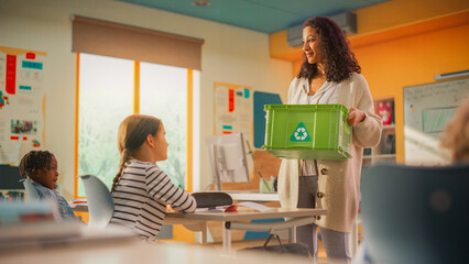 Elementary School Classroom: Enthusiastic Female Teacher Holding an Empty Plastic Bottle and a Box with a Recycling Label and Explaining Ecology and Sustainability Concepts to School Kids