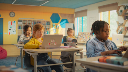 Portrait of Elementary School Children Learning Basic Computer Knowledge: Teacher Educating Smart...
