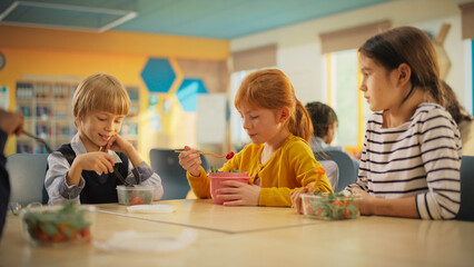 Class of Adorable Diverse Children Having a Lunch Break with Healthy Vegetarian Meals in an...