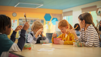 Elementary School Children Eating Healthy Food on a Lunch Break. Smart Diverse Kids Having Fun,...