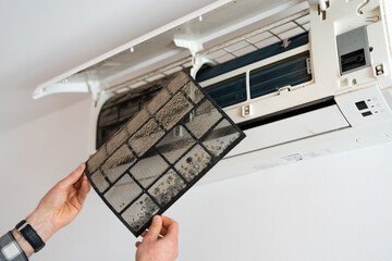 Air conditioner filter dusty. Preparation for maintenance and cleaning