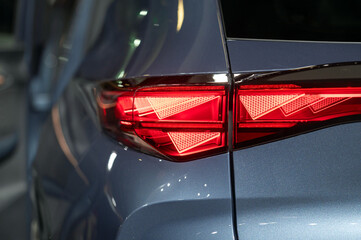 Close-up of the rear light of a modern car. Selective focus. - obrazy, fototapety, plakaty