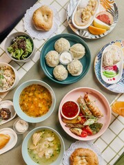 Uzbek Food, Dumplings, Soup, Salad, and Pastries on a Table