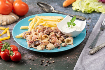 Fried squid, also known as calamari, are sliced into rings, lightly battered, and deep-fried until crispy. They are often served with a side of lemon wedges and a dipping sauce like tartar or marinara