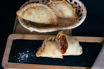 Argentinian beef empanadas with pepper, empanada cut in half, lots of filling, gastronomic