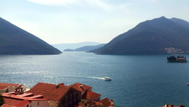 Aerial view of the Bay of Kotor from the historic town of Perast. Aerial view of Saint George Island and the Adriatic Sea. Perast, Montenegro. Europe.