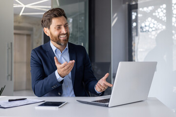 Handsome businessman engaging in a virtual meeting