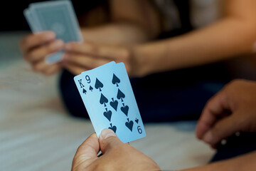 Close-up view of the cards in the player's hand. Get King and 9 Spades cards. Concept Play cards at...