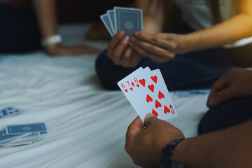 Close-up view of the cards in the player's hand. Cards arranged 6,7,8 hearts. Concept Play cards at leisure or as a hobby. Soft and selective focus.