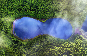 Aerial top down view of beautiful green waters of lake. Birds eye view of scenic emerald lake...