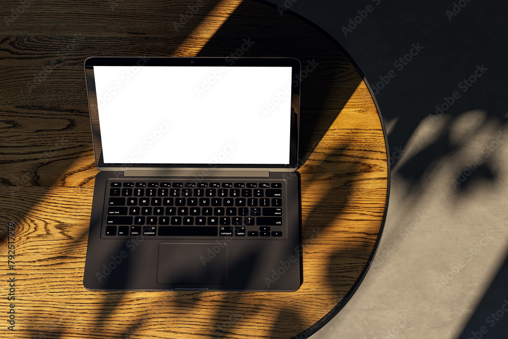 Aufkleber top view of modern designer desktop with white mock up laptop on wooden desk, sunlight and shadows. 