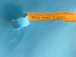This year i will text behind torn paper background. New year resolution concept. Stock photo