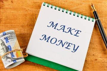 Business concept , business idea,business analysis. MAKE MONEY on a notepad near money and a...