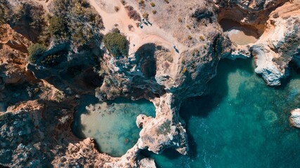 Aerial shot sea surrounded by cliffs sunlight algarve portugal