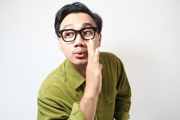 Adult Asian man telling something gesture with happy expression 
