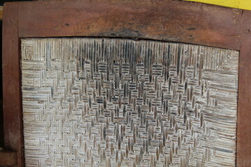 Close up of patterned rattan weaving that is dull and dirty, suitable for backgrounds and tectures.