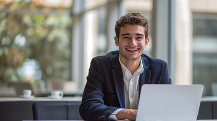 Portrait of a businessman working on laptop.