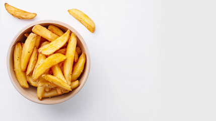 Cooked wedges potatoes in a bowl on a white table, top view, space on the right