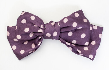 Purple and lilac polka dot hair bow isolated on white