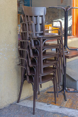 Stack of Brown Chairs and Tables in Front of Restaurant