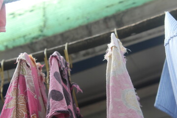 Clothes drying on the clothesline. Clean clothes hanging on washing line against sky. Drying laundry
