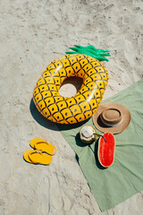 summer beach vacation Swimming rings, sponge shoes and fruit at the beach
