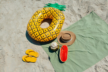 summer beach vacation Swimming rings, sponge shoes and fruit at the beach