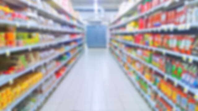 Abstract blur image of supermarket background. Defocused shelves with products. Grocery store. Retail industry. Discount. Inflation and recession concept. Aisle. Consumer packaged goods. CPG. Rack.