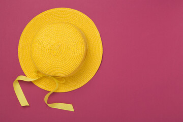 Yellow hat on color background, top view. Summer concept
