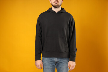 A guy in a black hooded sweatshirt