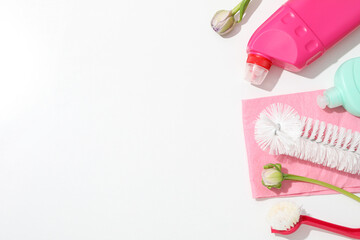 Detergents with rag and flowers on white.background