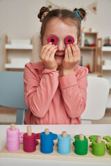 Little girl having fun with Montessori toys