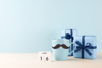 Father's Day celebration concept featuring a blue mug with a whimsical mustache design, neatly...