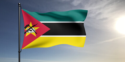 Mozambique national flag cloth fabric waving on beautiful grey sky Background.