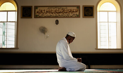 Muslim, praying and spiritual man in mosque for worship of God, Allah and mindfulness for peace....