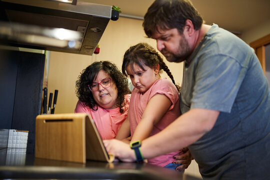 A family looking in the digital tablet a healthy recipe
