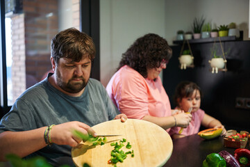 Family in a vegetables diet. Preparing healthy lunch at home kitchen.