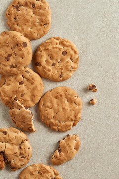 Chocolate chip cookies arranged on a textured surface