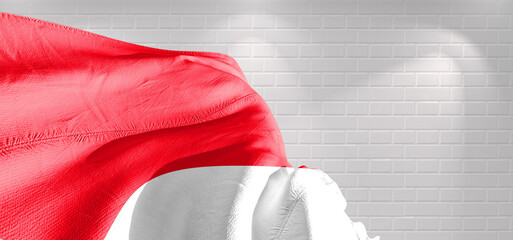 Indonesia national flag cloth fabric waving on beautiful bricks Background.	

