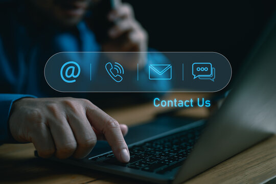 Contact us or Customer support hotline people connect. Businessman using a laptop with virtual screen contact icons ( email, address, live chat, phone ).