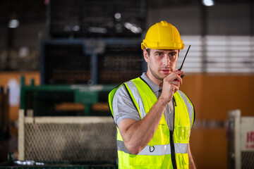 Male professional walkie talkie control worker in warehouse. Supervisor import-export shipping...