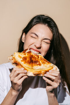 Woman Enjoying a Delicious Baked Cheburek