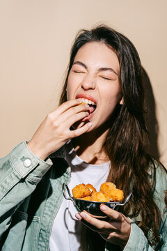 Woman enjoying delicious fried mozzarella bites
