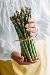 Close up of elderly woman's hands with asparagus